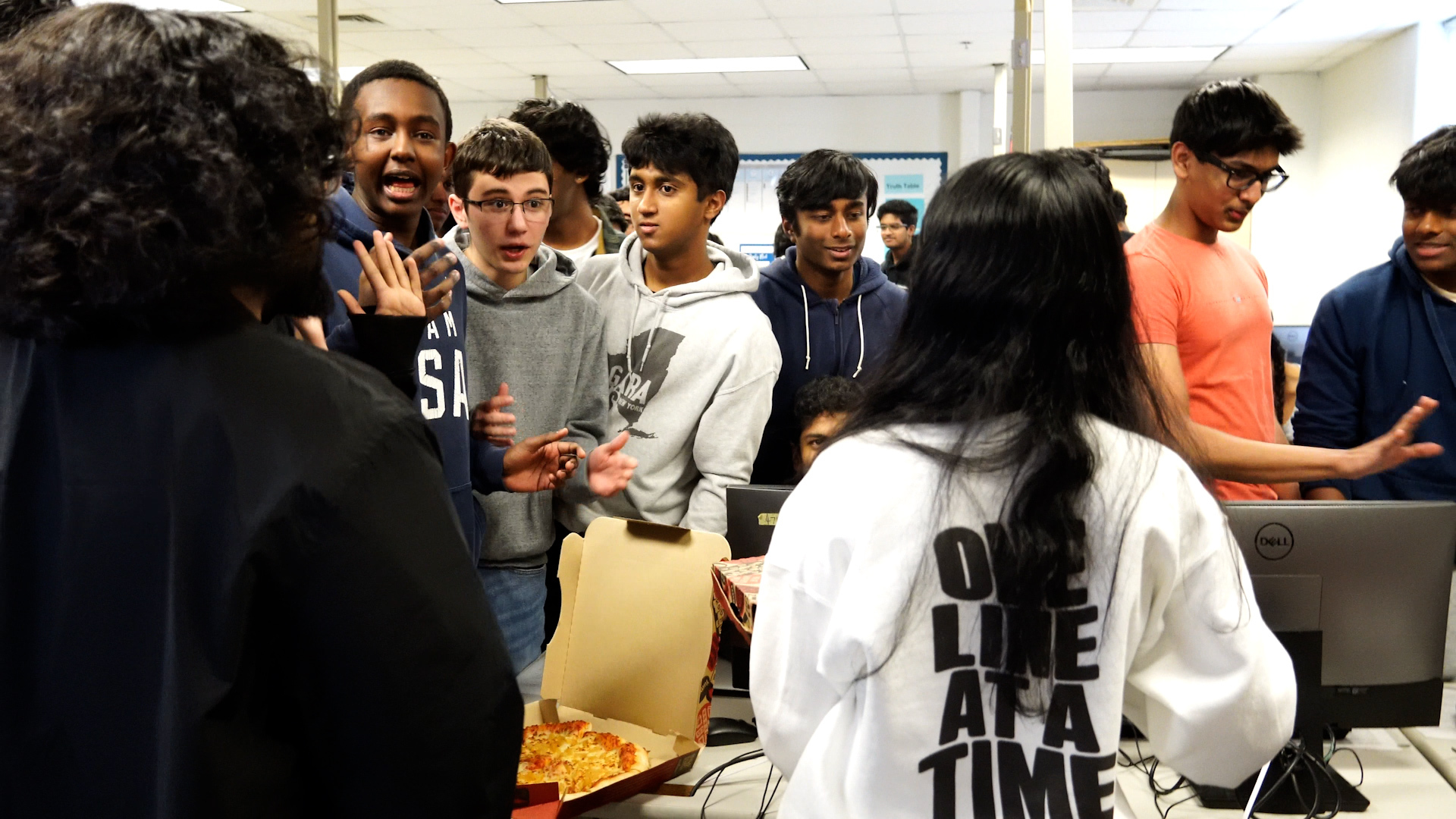 pizza being distributed at hack club meeting